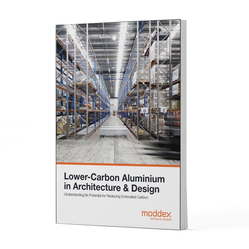 Lower-carbon aluminium in architecture and design whitepaper cover, illustrating aluminium materials and logistics used to reduce embodied carbon in construction.